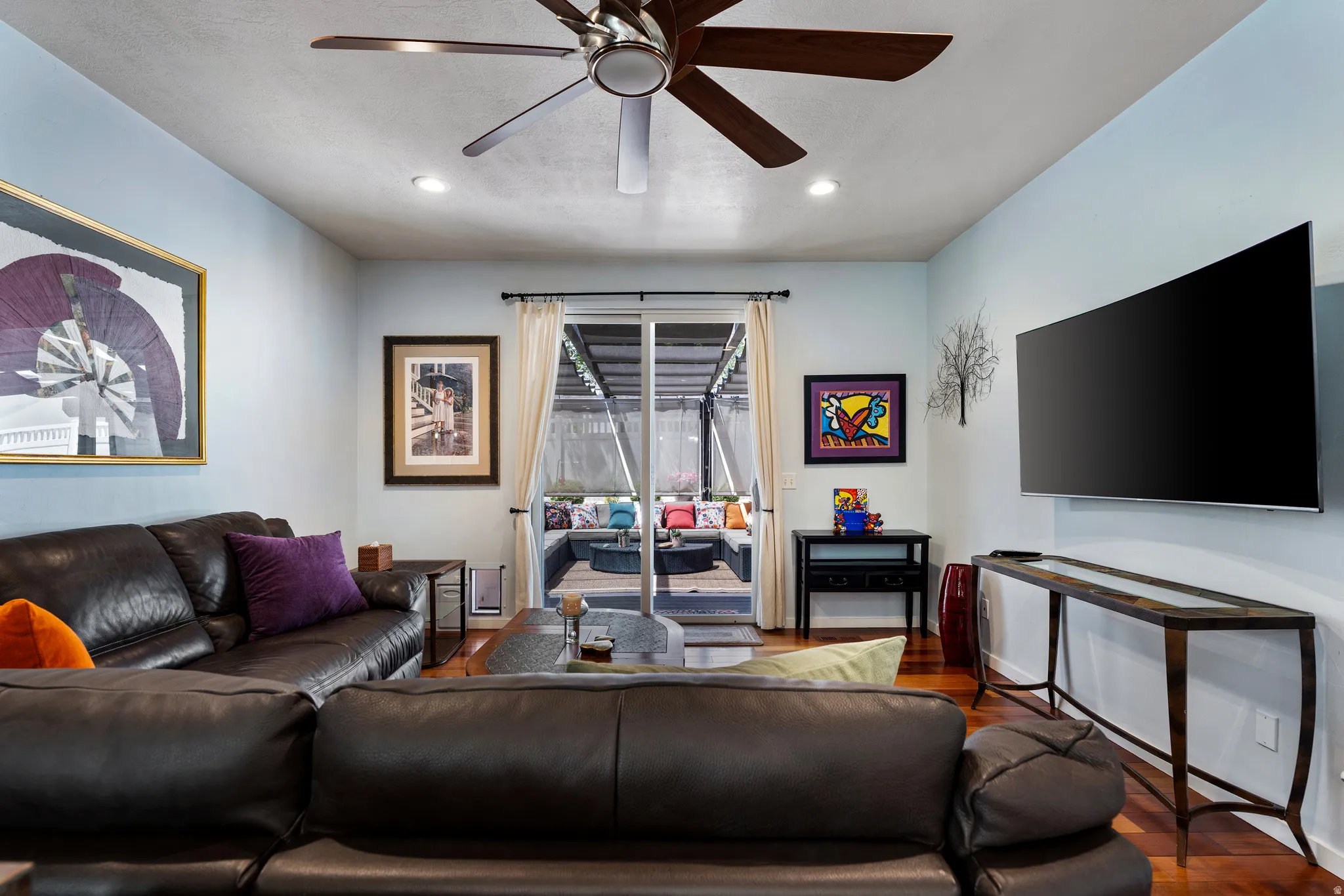 Living area featuring wood-finish flooring, recessed lighting, and a ceiling fan