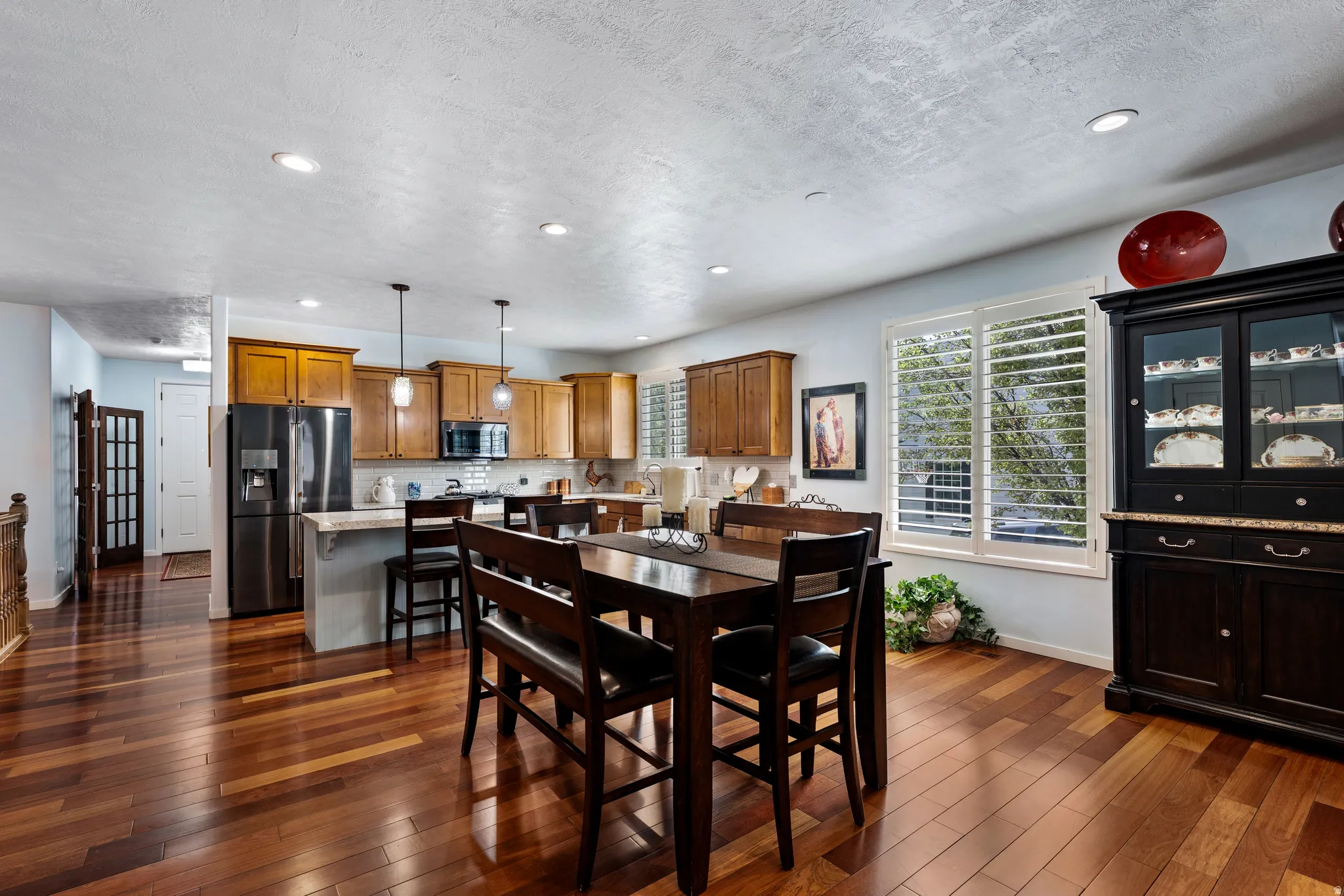 Open-concept living space with wood-finish flooring