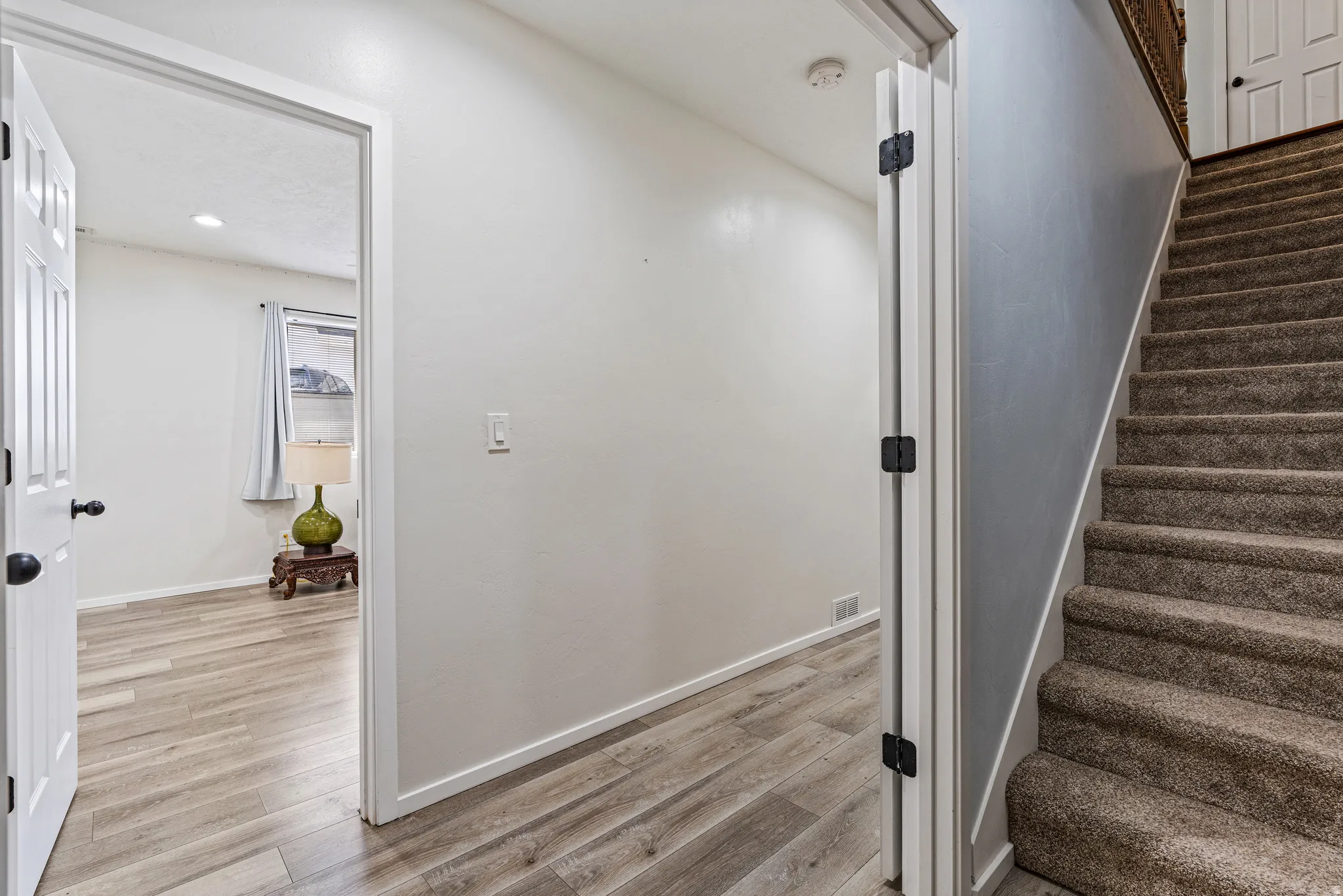 Carpeted staircase with white trim, leading to an upper level