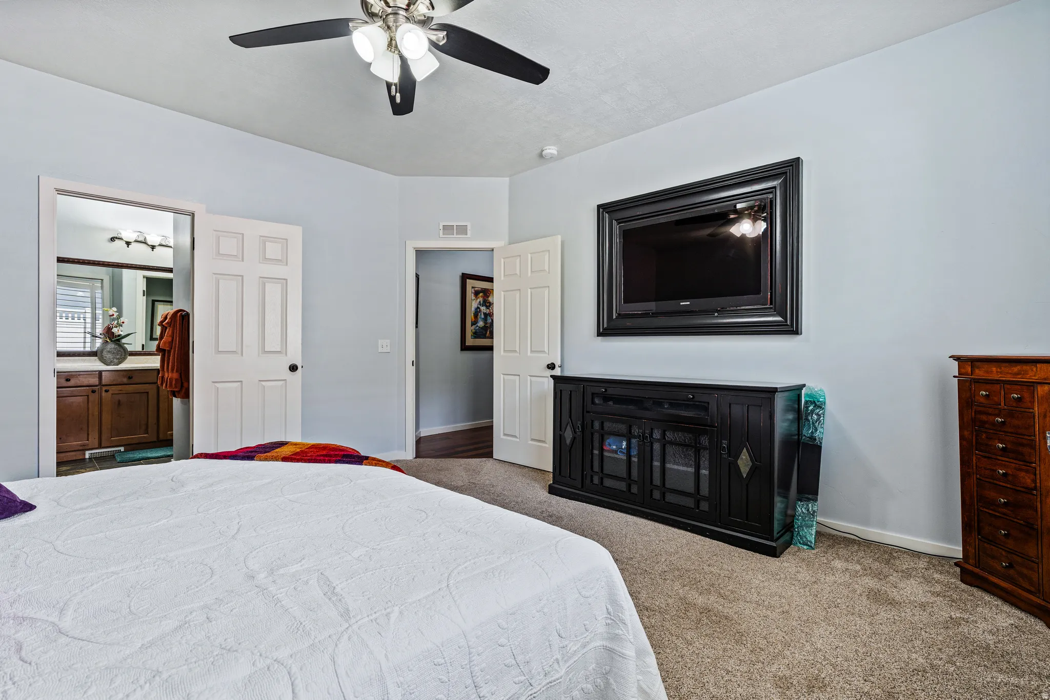 Spacious room featuring light-colored walls and carpeted flooring