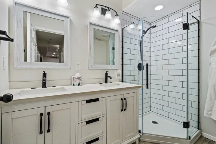Dual vanity with matte black fixtures and light-colored countertops