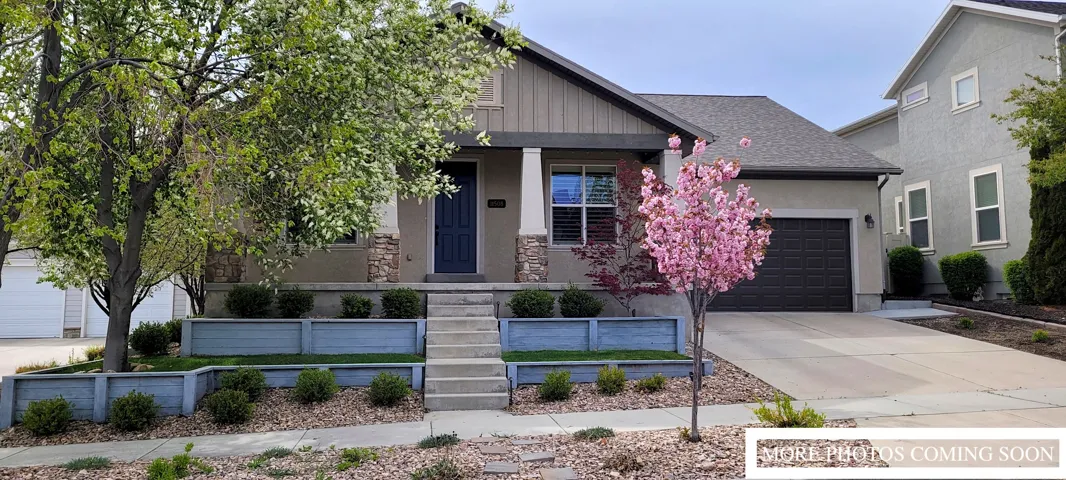 Contemporary exterior with a dark blue entry door, stone accents, and a covered front porch
