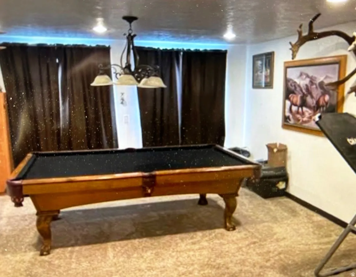 Recreation room featuring a built-in billiard table, recessed lighting, and a prominent chandelier