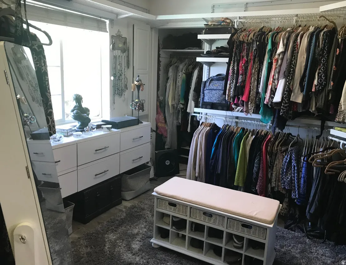 Custom closet system featuring extensive hanging rods and open shelving