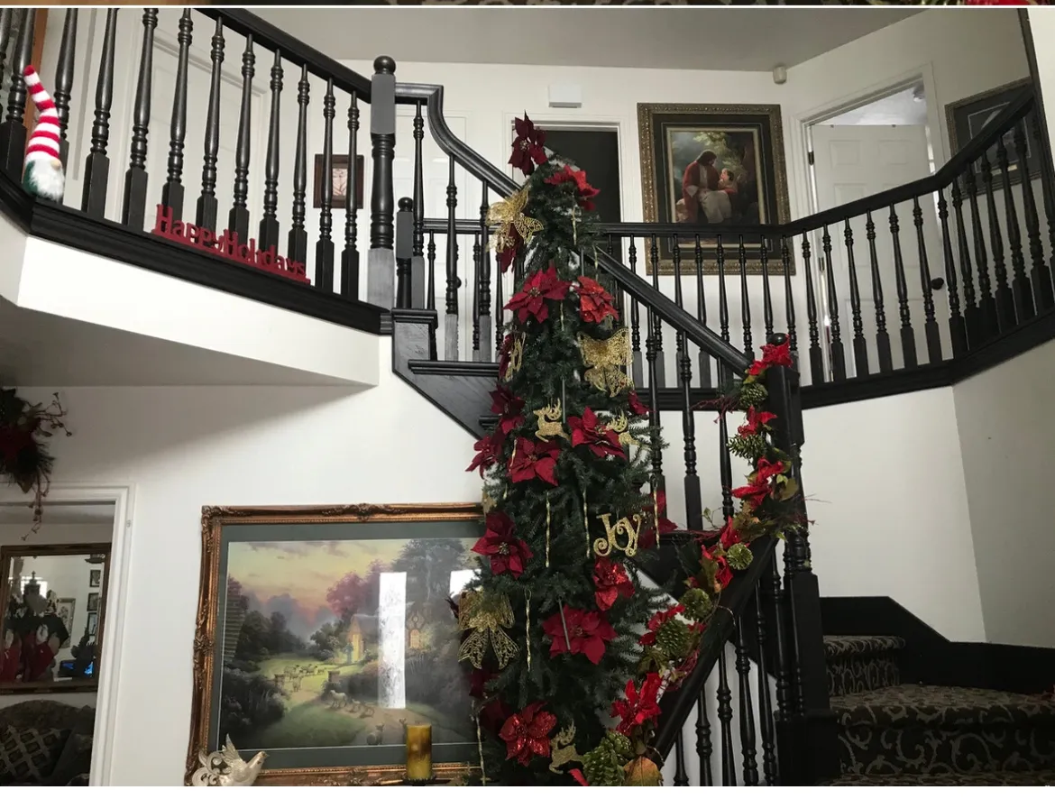 Grand two-story foyer featuring a black balustrade staircase