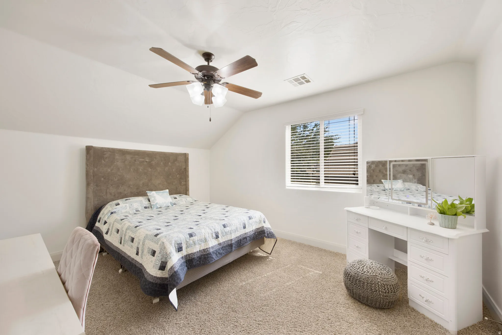 Carpeted room with a ceiling fan, a window with blinds, and white walls