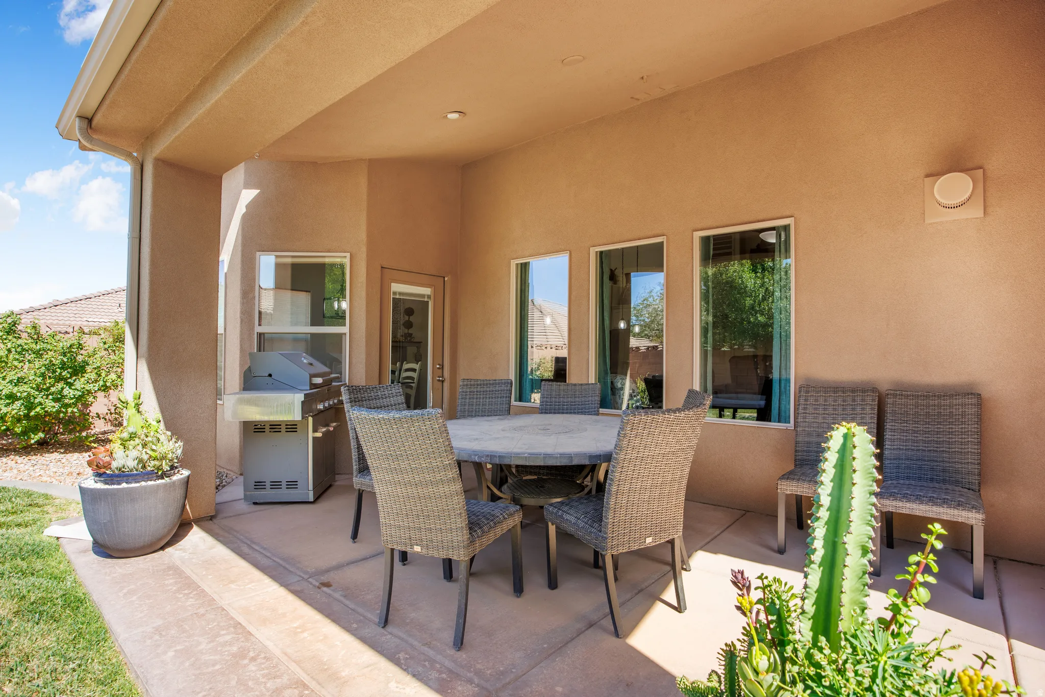 Covered patio featuring a concrete slab and stucco finish
