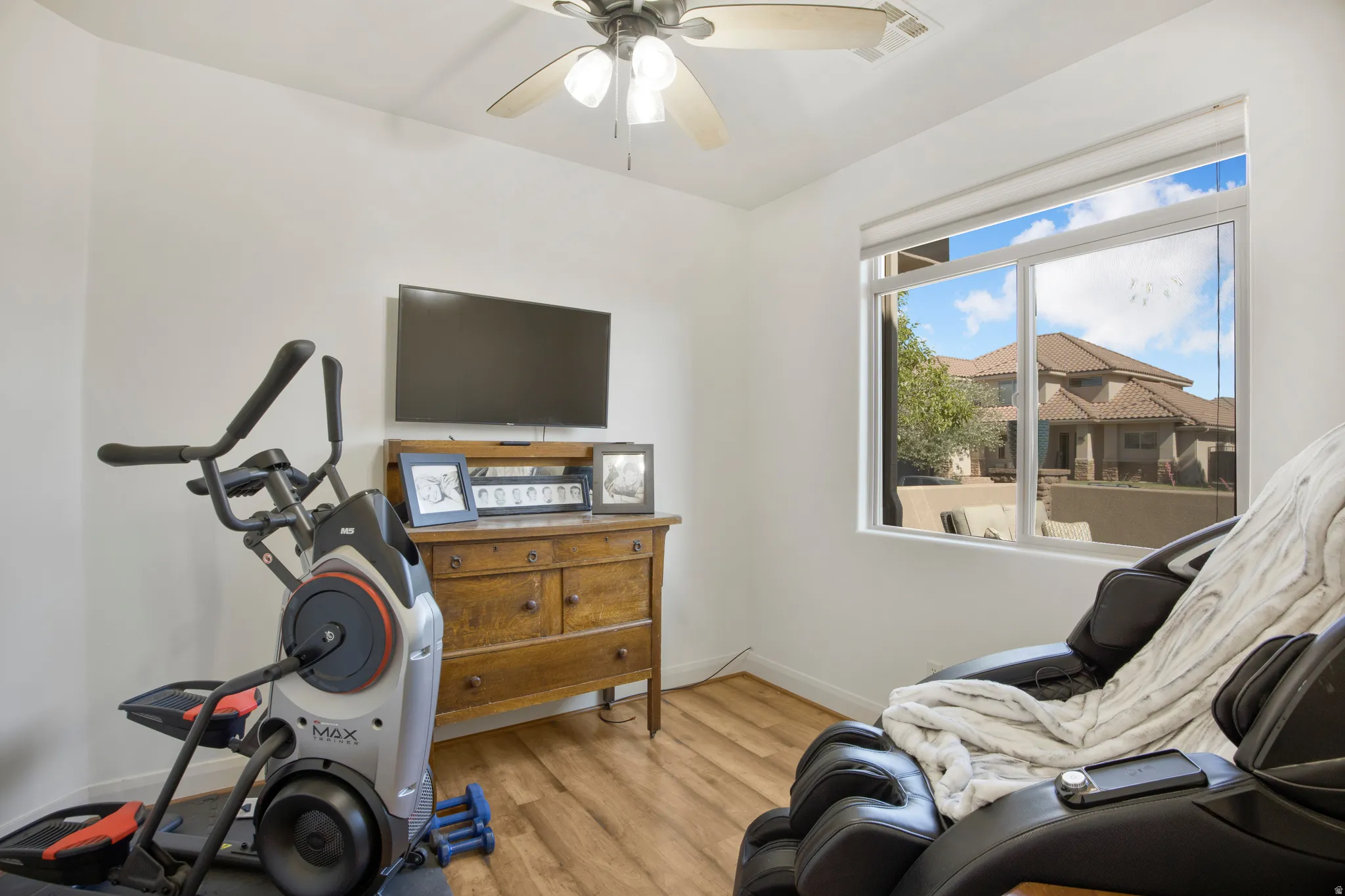 Room featuring neutral wall tones and wood-finish flooring