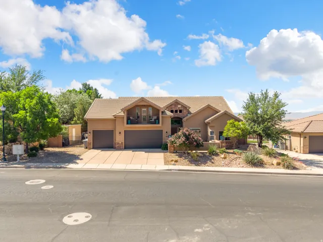 Stucco exterior with a tiled roof and stone accents