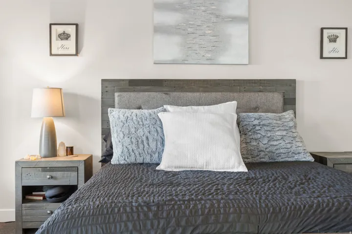 Reclaimed wood-finish headboard and matching nightstands