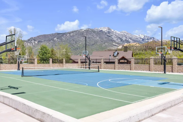 Multi-sport court featuring integrated basketball hoops and a tennis net