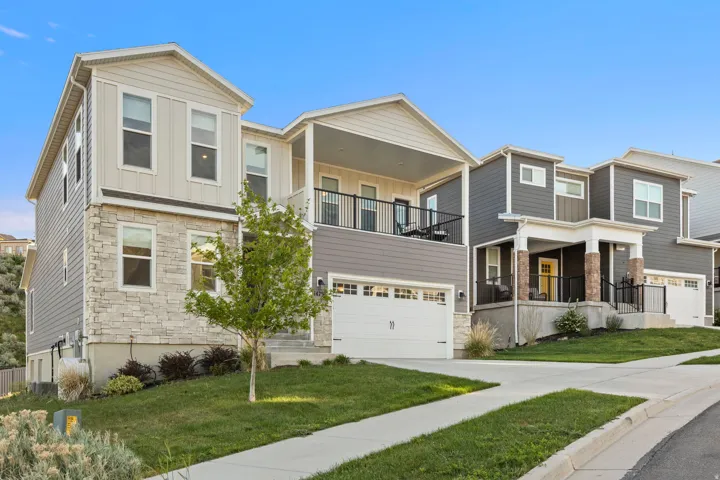 Contemporary multi-level residence featuring a stone and siding exterior
