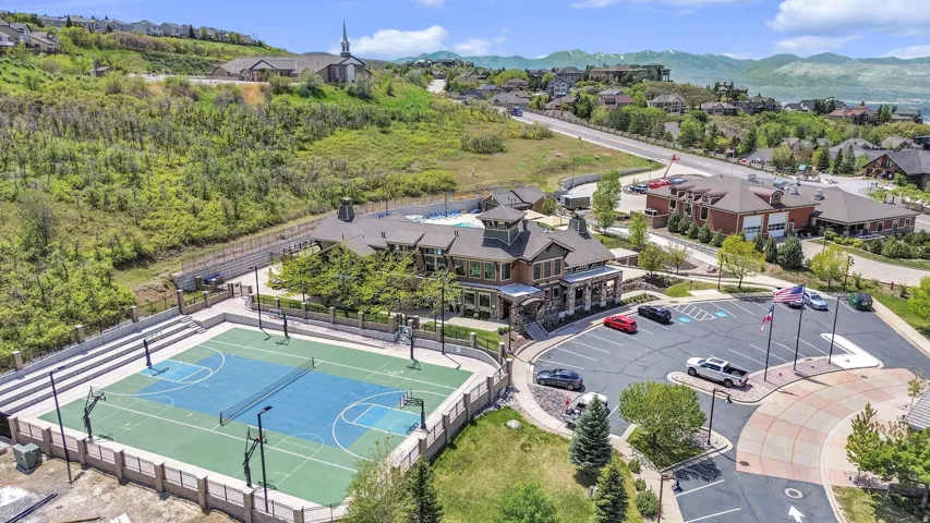 Multi-sport court featuring basketball hoops and a tennis net