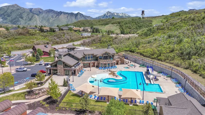Expansive recreation center featuring a multi-level swimming pool, water slides, and a separate hot tub