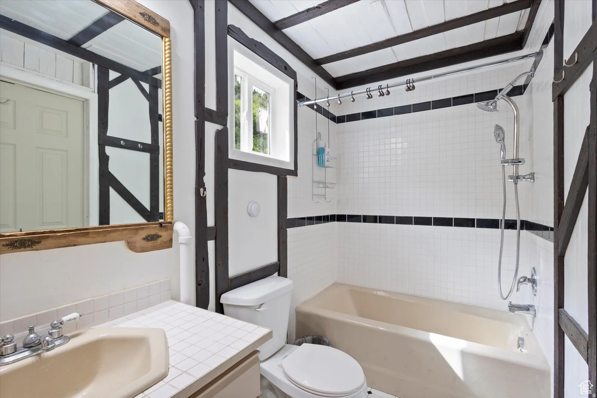 Bathroom with bathing tub /shower combination.