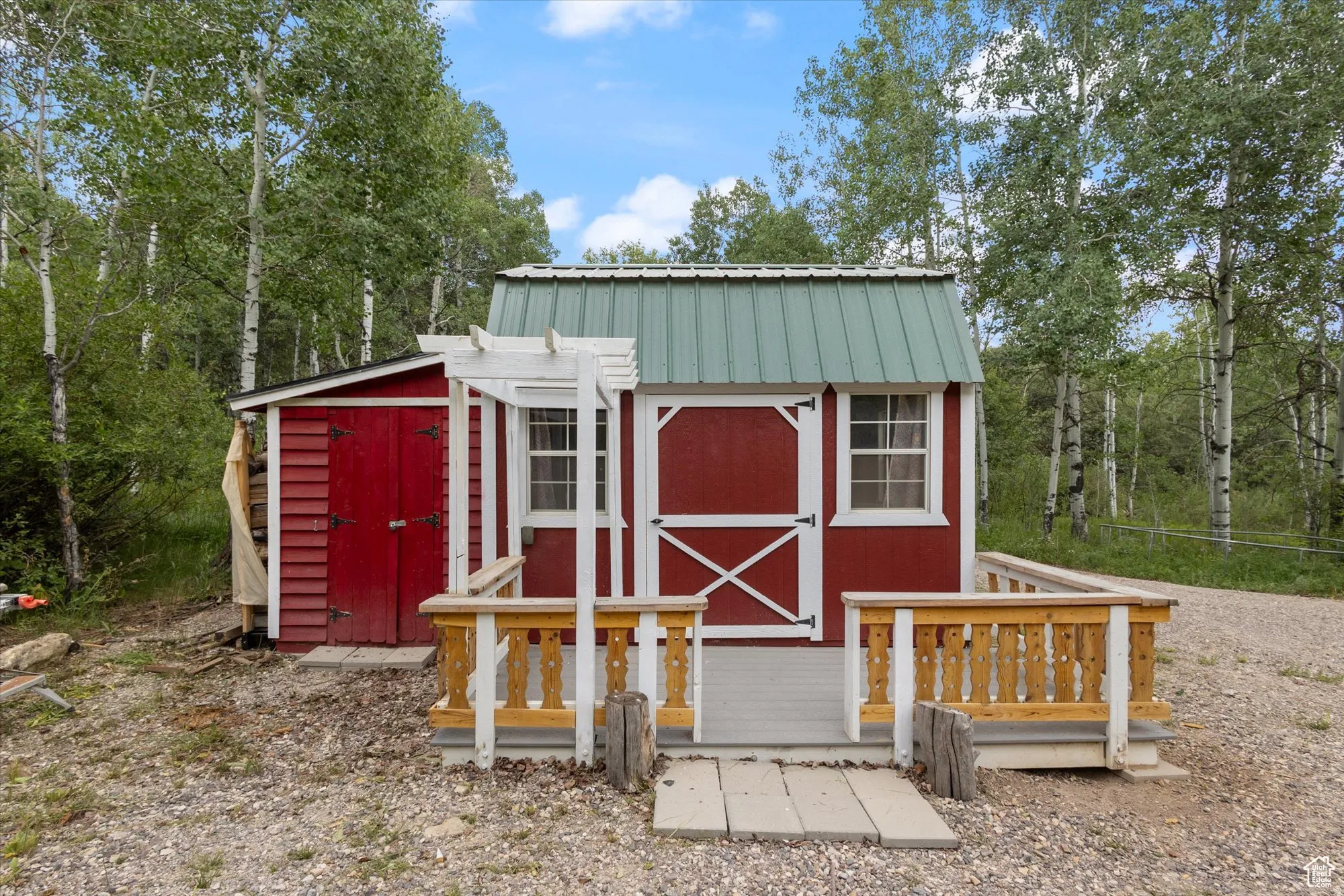 Isn't the bunkhouse adorable? The lean-to on the left houses yard tools. Notice the metal roof.