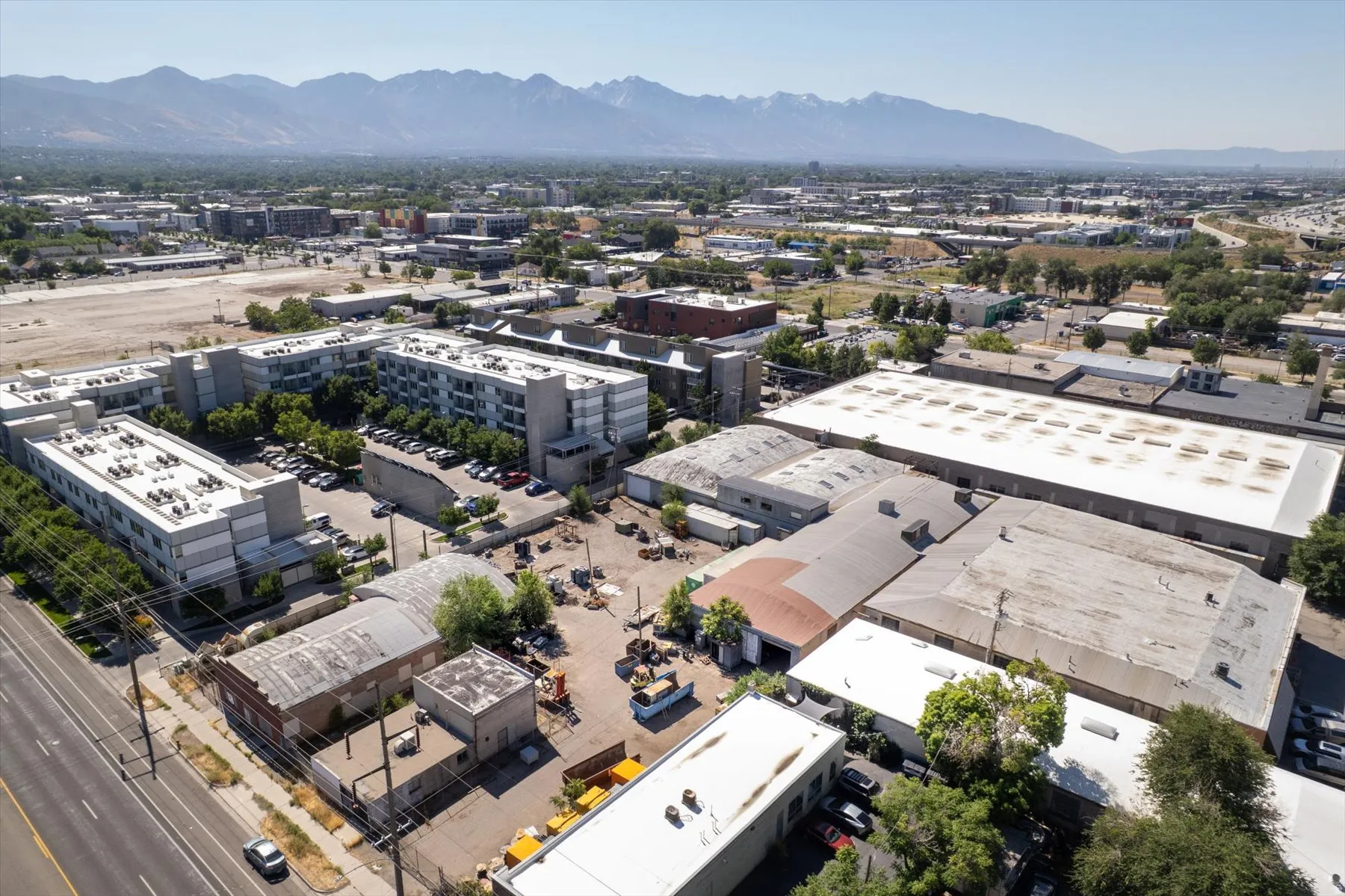Expansive industrial property featuring multiple buildings with large footprints, flat roofs, and corrugated metal siding