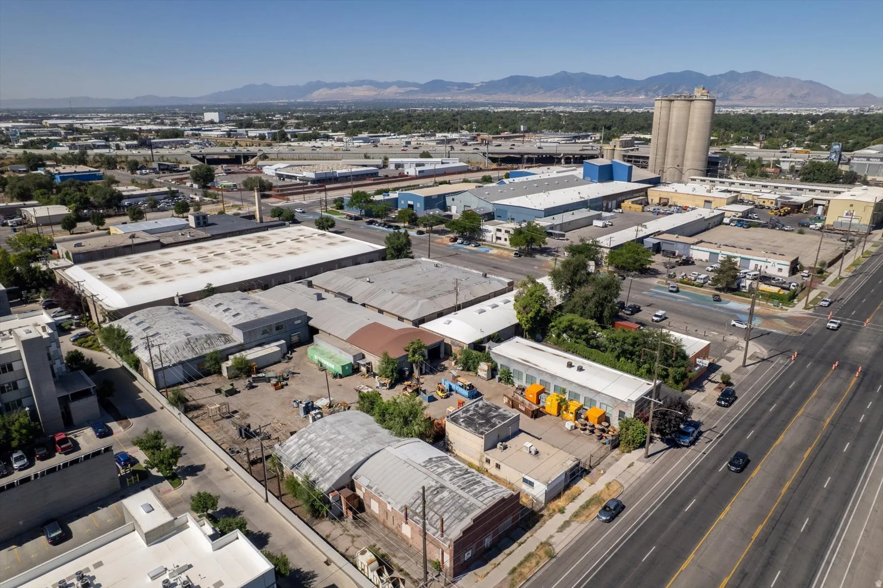 Industrial property featuring multiple buildings with metal roofs and various lot configurations