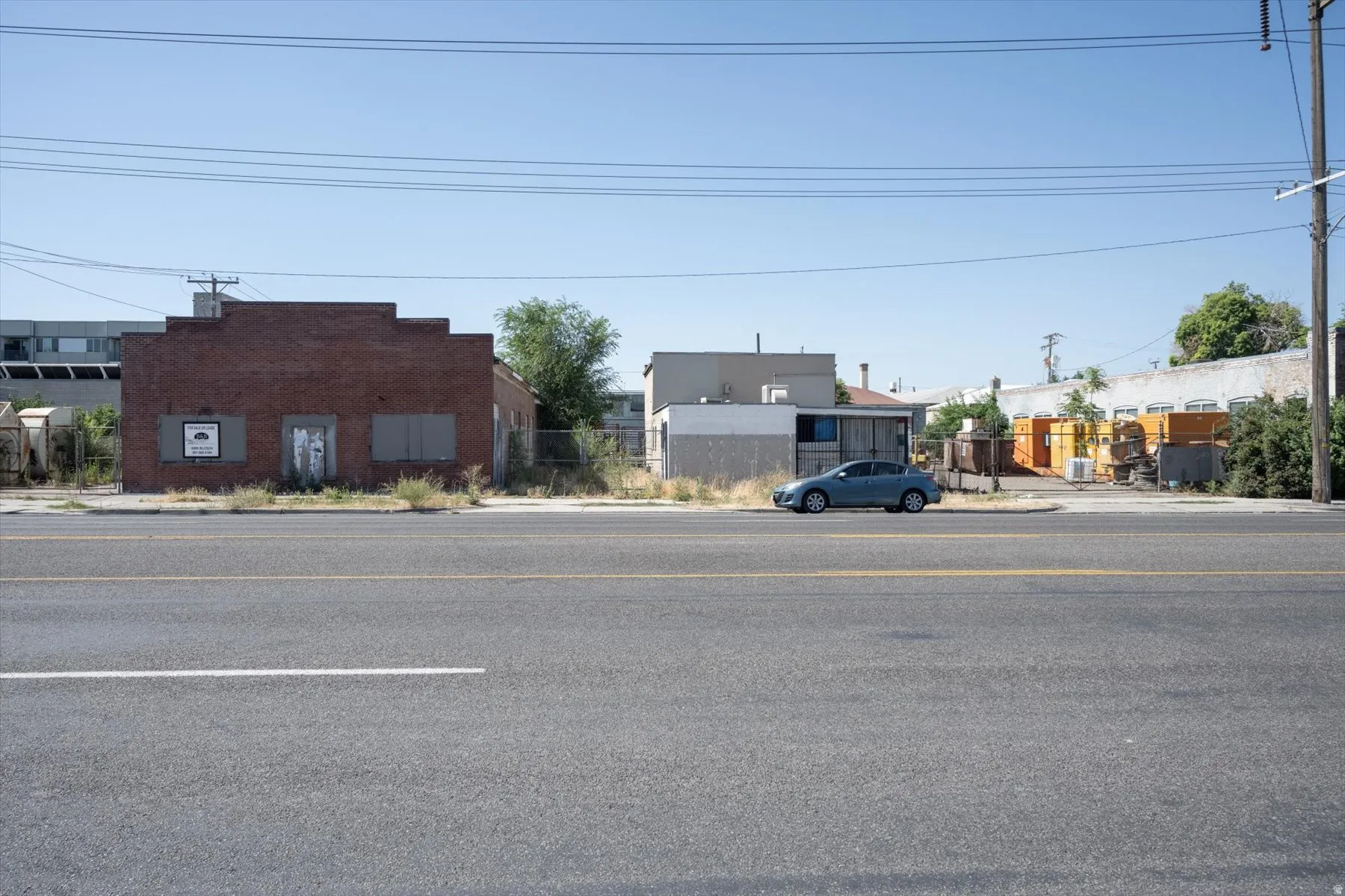 Commercial building featuring a brick facade and boarded windows