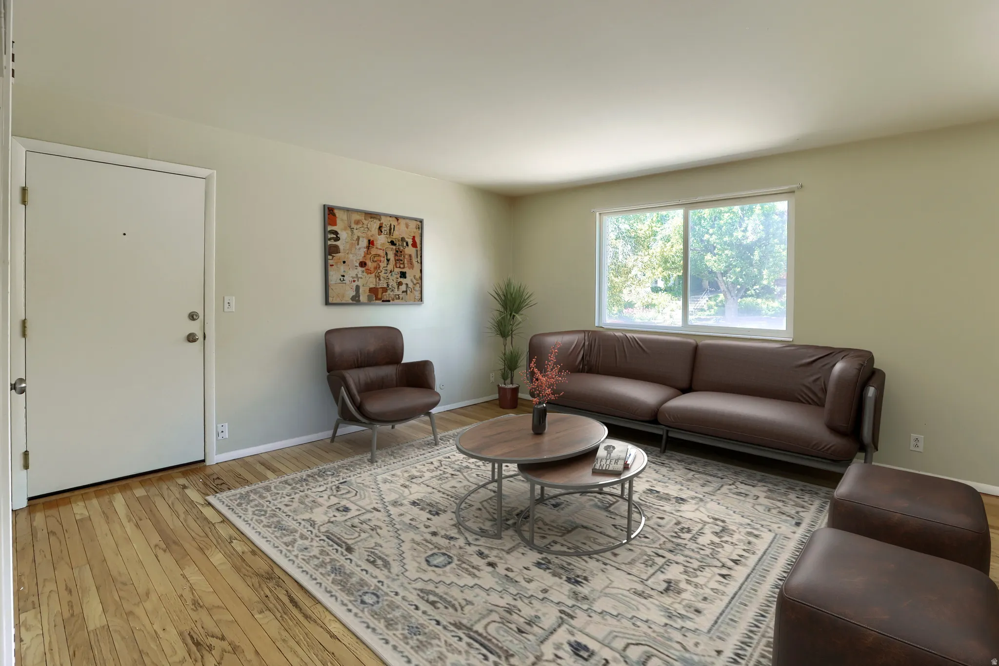 Light-toned walls complement wood-finish flooring throughout this living space