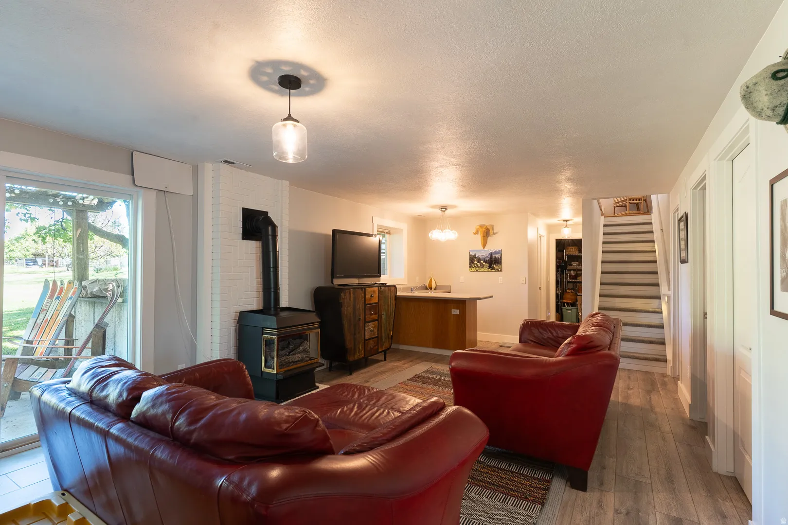 Walk out to the pergola patio with your drink from the wet bar, or stay cozy next to the gas fireplace watching the big screen. You'll love the updated defining light fixtures throughout the home !