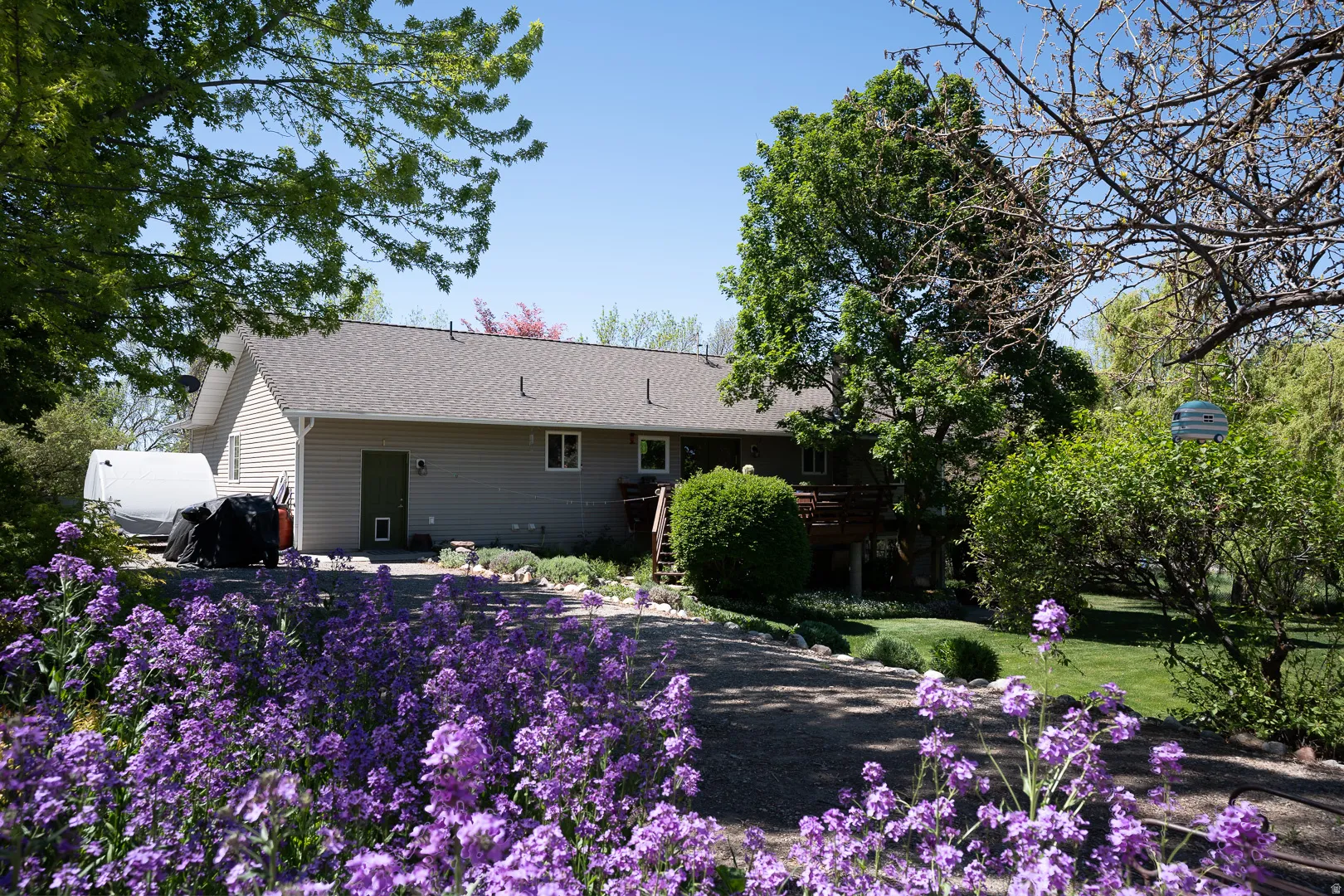 Manicured landscaping with a spacious walk way, to garden and back fruit trees.  Possibilities are endless for small animals, or back yard play place!