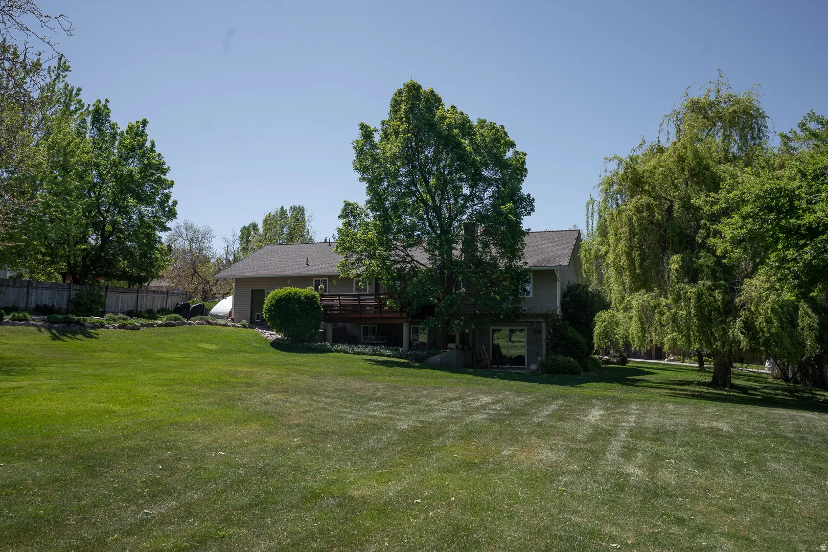 View of the back yard and back of home on the .78 acre lot.