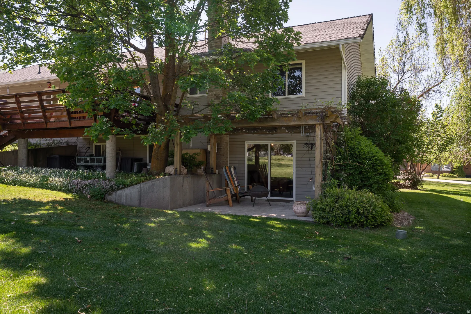 Back yard under the curly willow tree, with walkout basement and pergola, this could be the walk in for an  AUD.