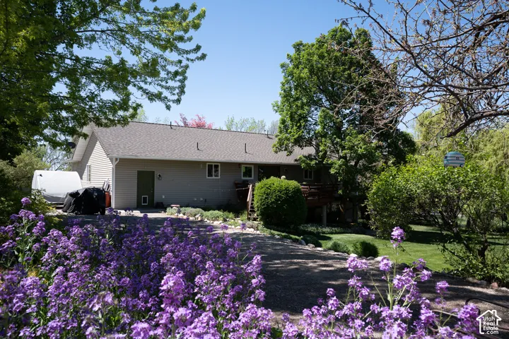 Manicured landscaping with a spacious walk way, to garden and back fruit trees.  Possibilities are endless for small animals, or back yard play place!