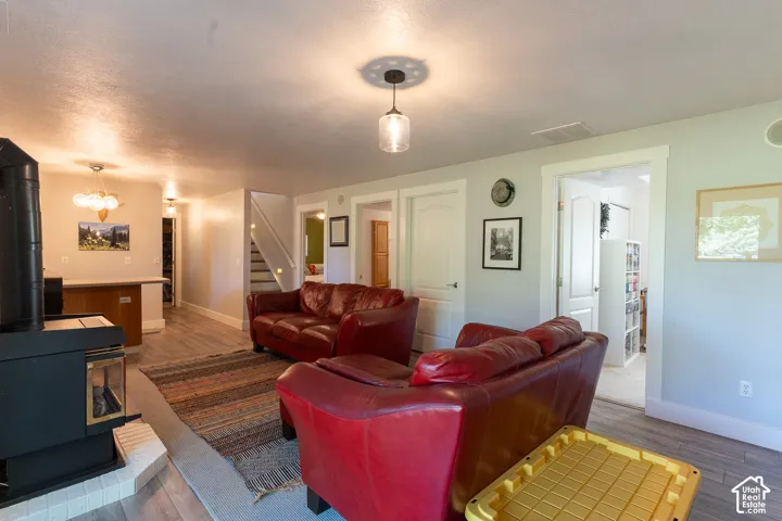 Living area featuring a gas stove with a tile hearth.  There is a laundry hook-up in the basement!