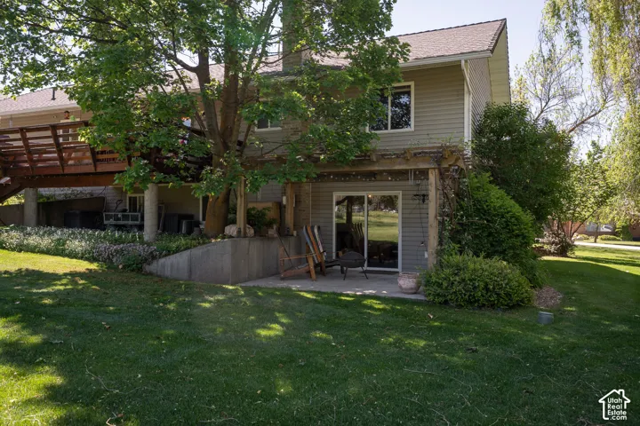 Back yard under the curly willow tree, with walkout basement and pergola, this could be the walk in for an  AUD.