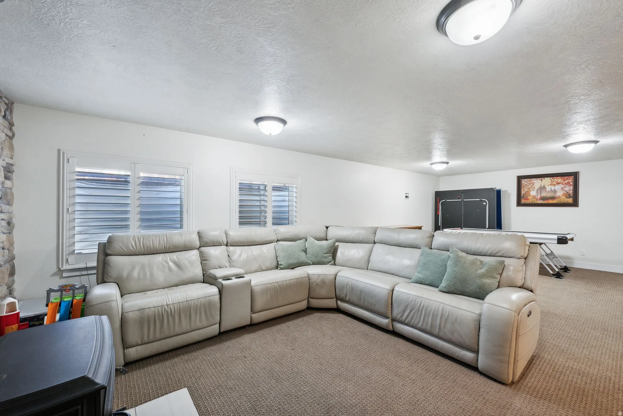Spacious room featuring neutral carpeting and white walls
