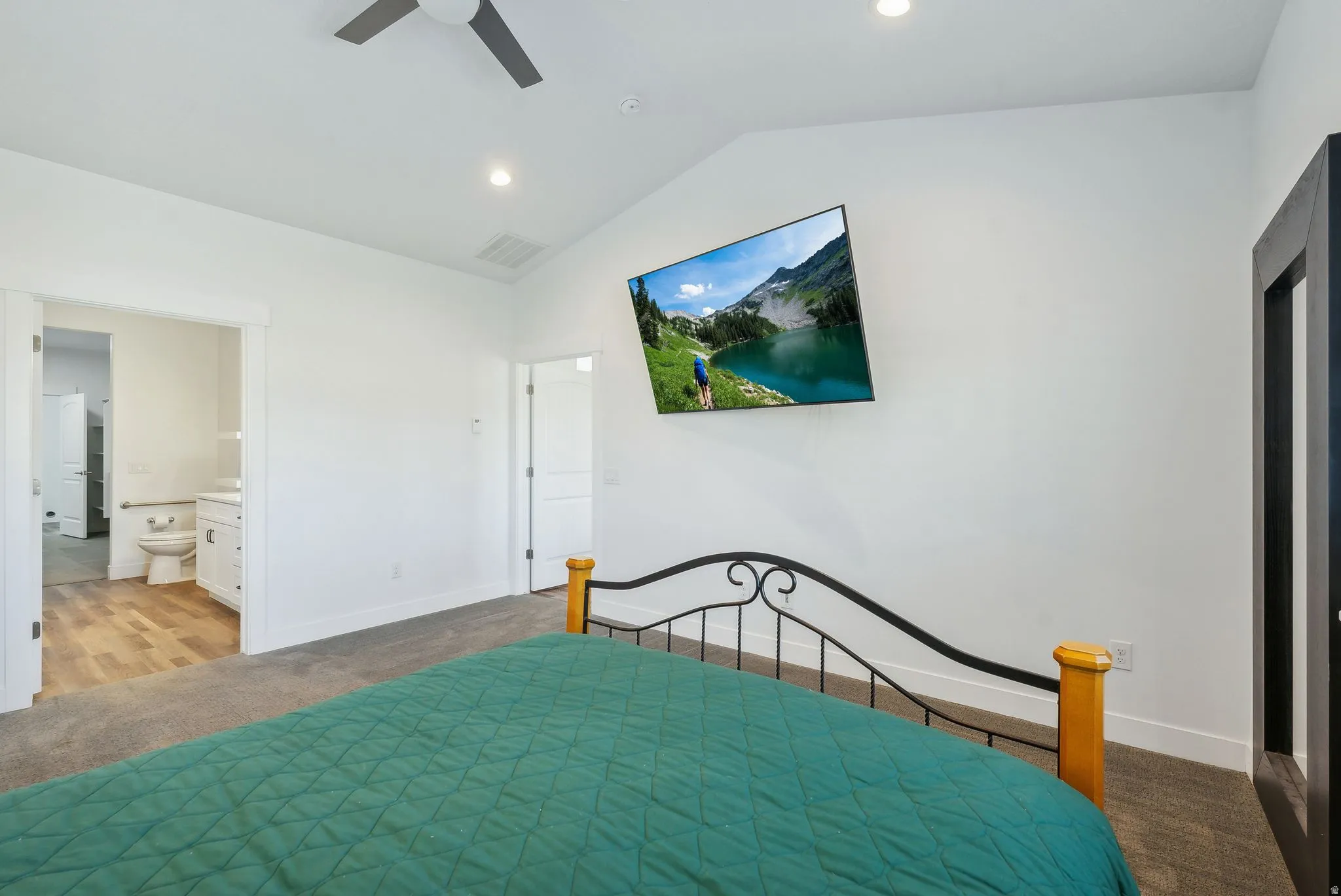 Custom built ADU/Bedroom with vaulted ceiling, recessed lighting, and a contemporary ceiling fan