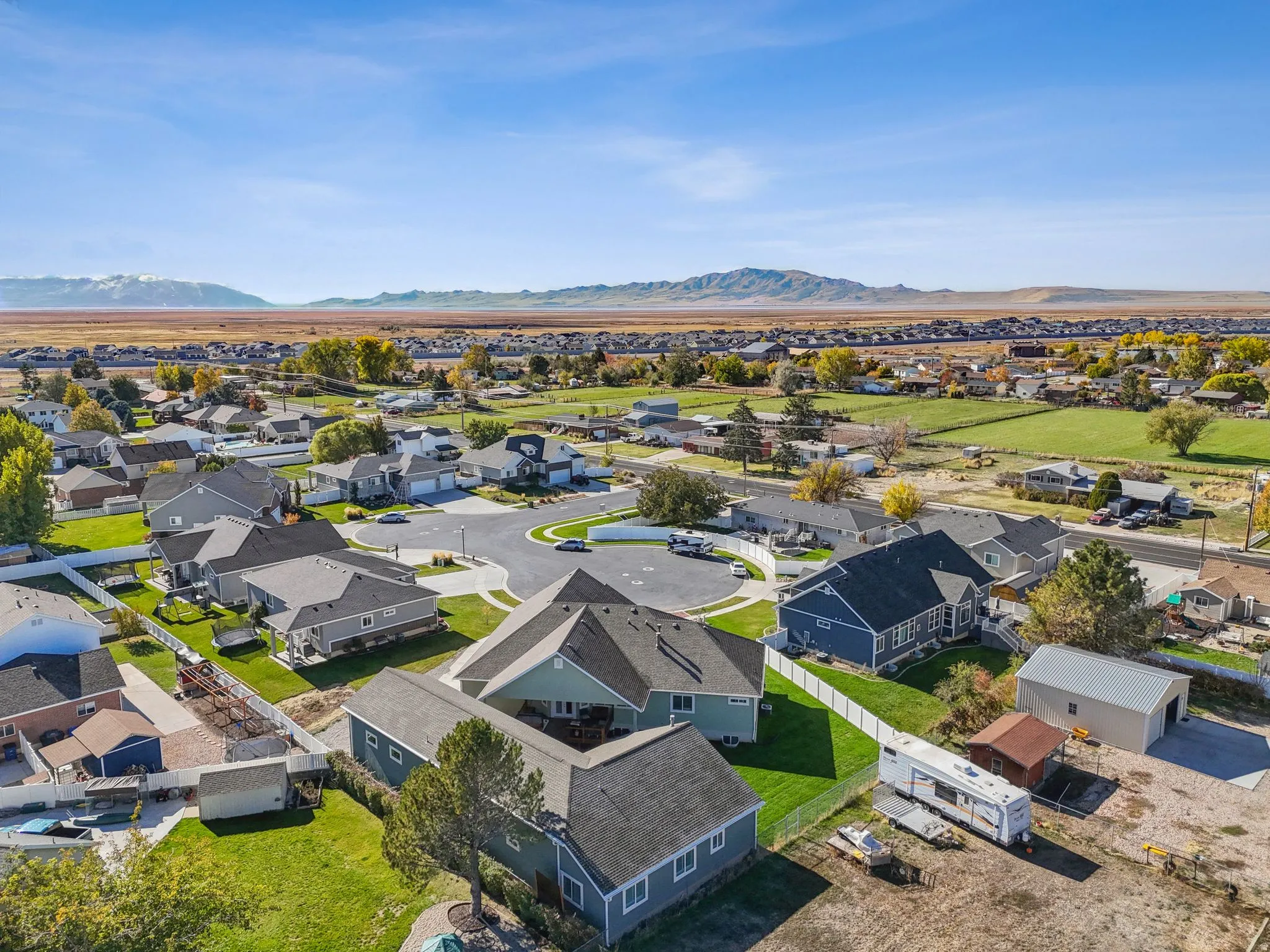Aerial perspective showcasing a residential community with distant mountain scenery