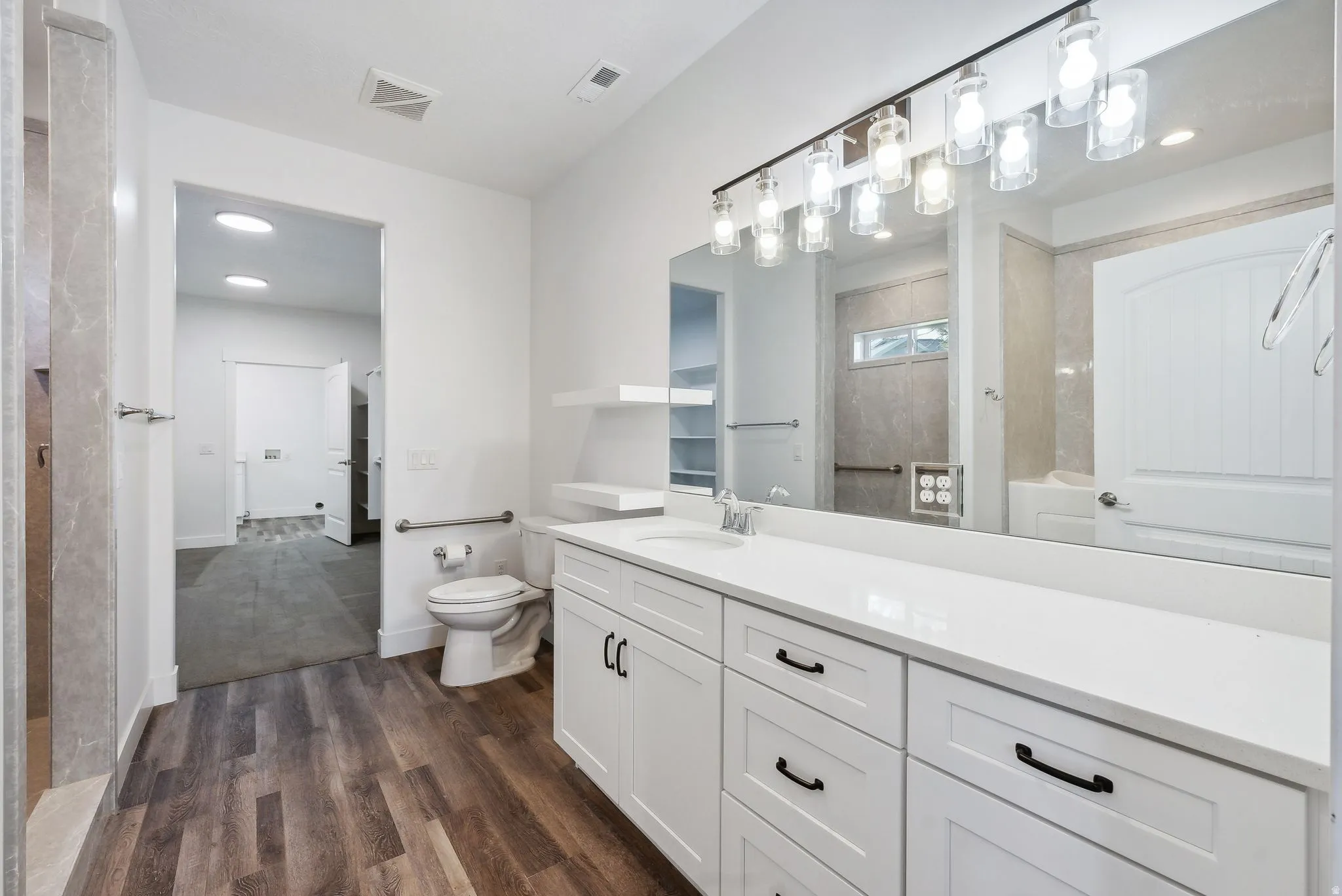 Custom built ADU/Spacious bathroom featuring a double vanity with white cabinetry and a light-colored countertop