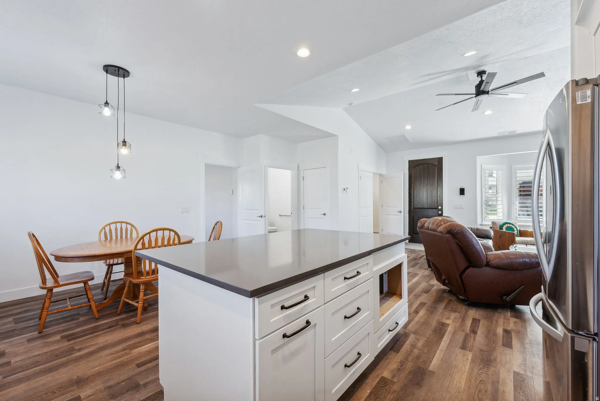 Custom built ADU/Kitchen island with white cabinetry and dark countertop