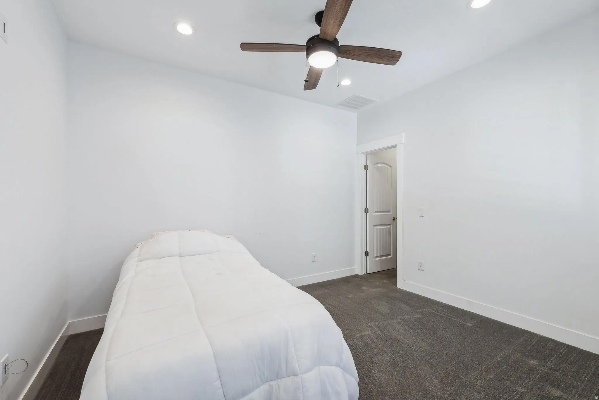 Custom built ADU/Bedroom featuring a ceiling fan with integrated lighting, recessed lighting, white trim, and dark gray carpet flooring