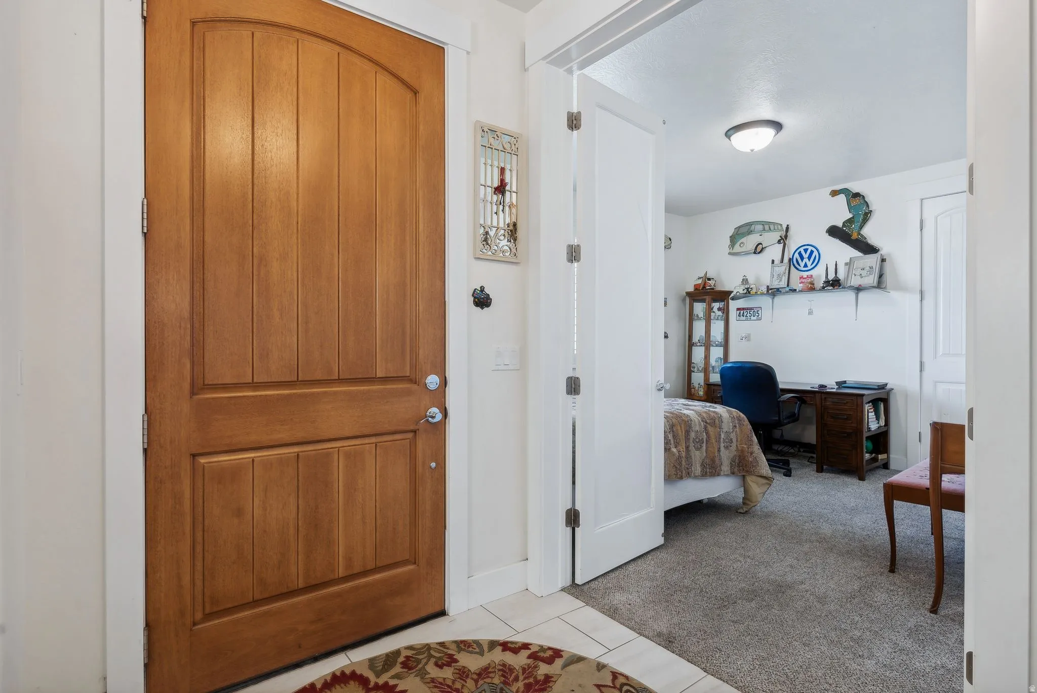 Entryway featuring a natural wood-finish door with an arched top panel