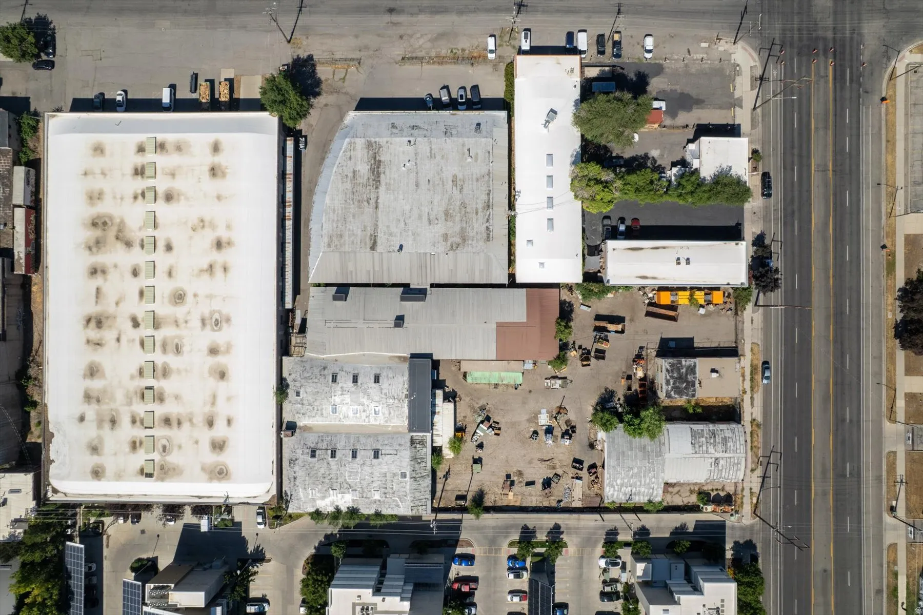 Aerial perspective showcasing multiple commercial structures and associated parking areas