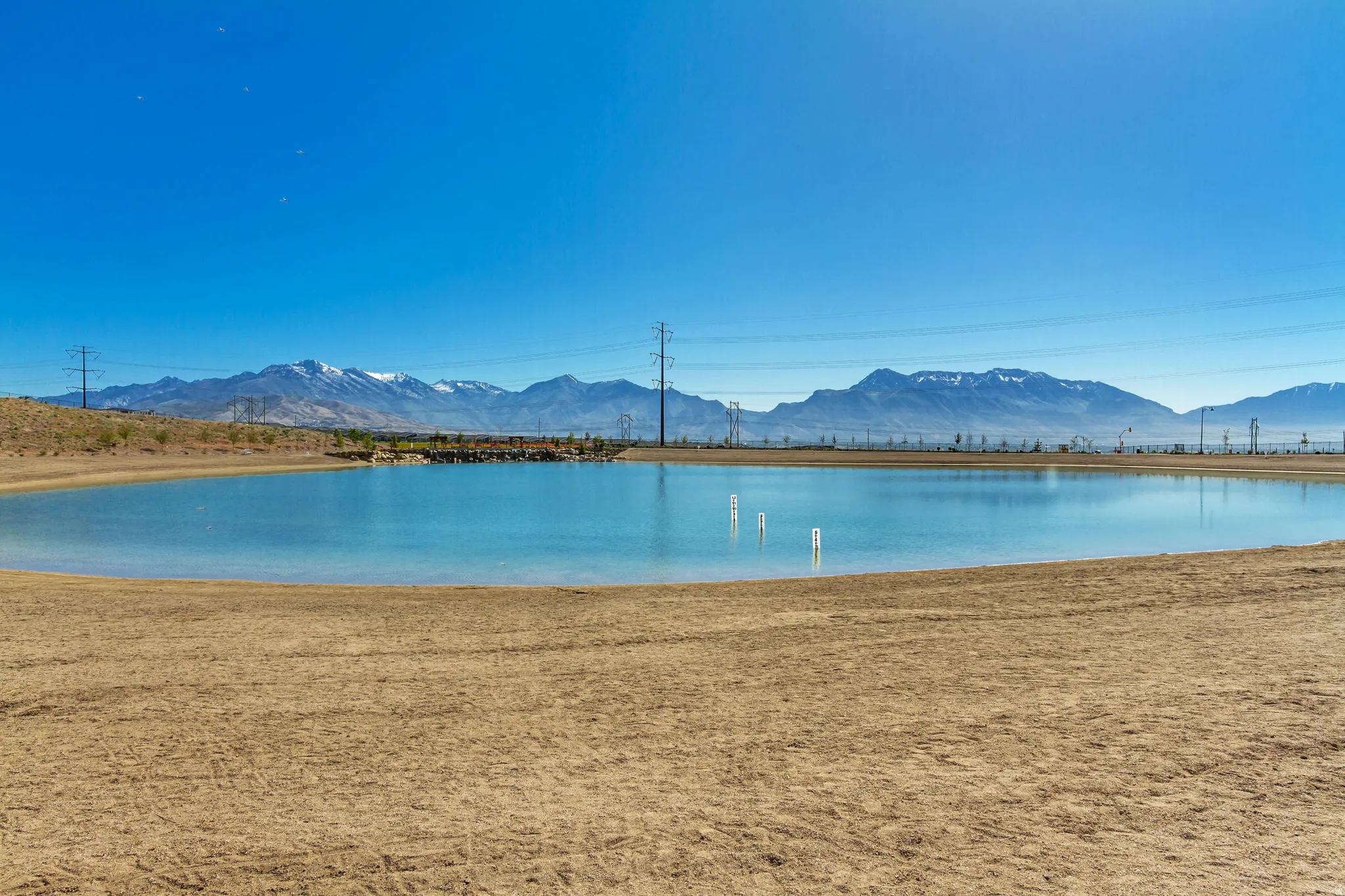 Expansive body of water with a natural sandy bank