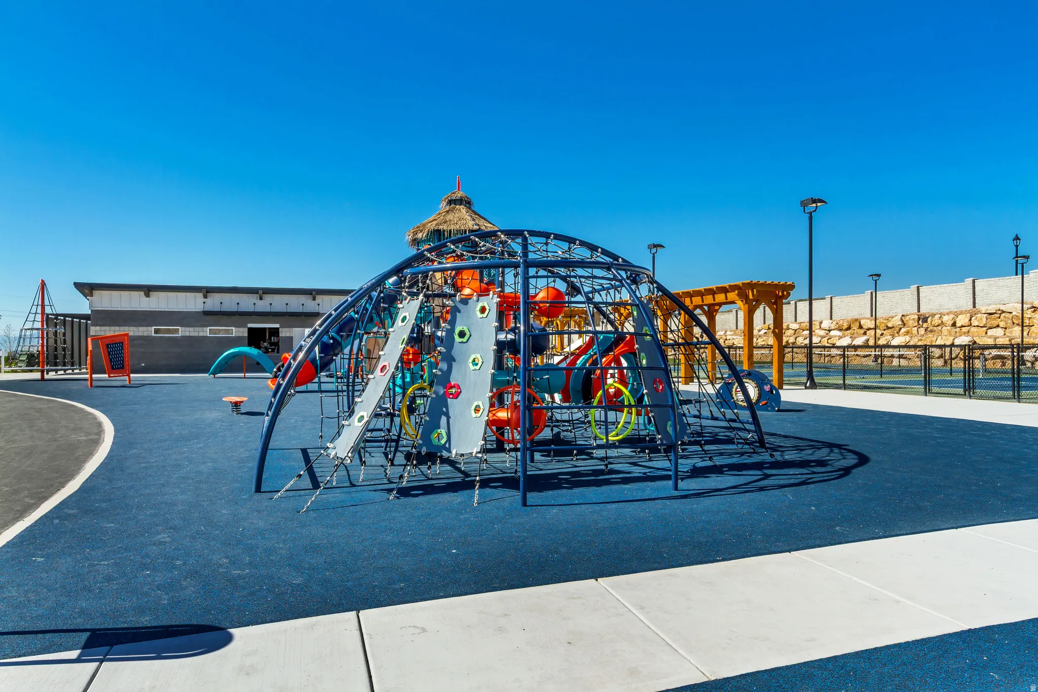 Community playground featuring extensive climbing structures and a soft-fall surface