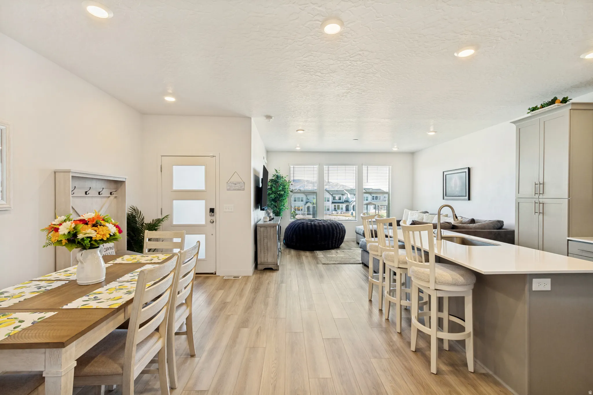 Open concept living area featuring wood-finish flooring