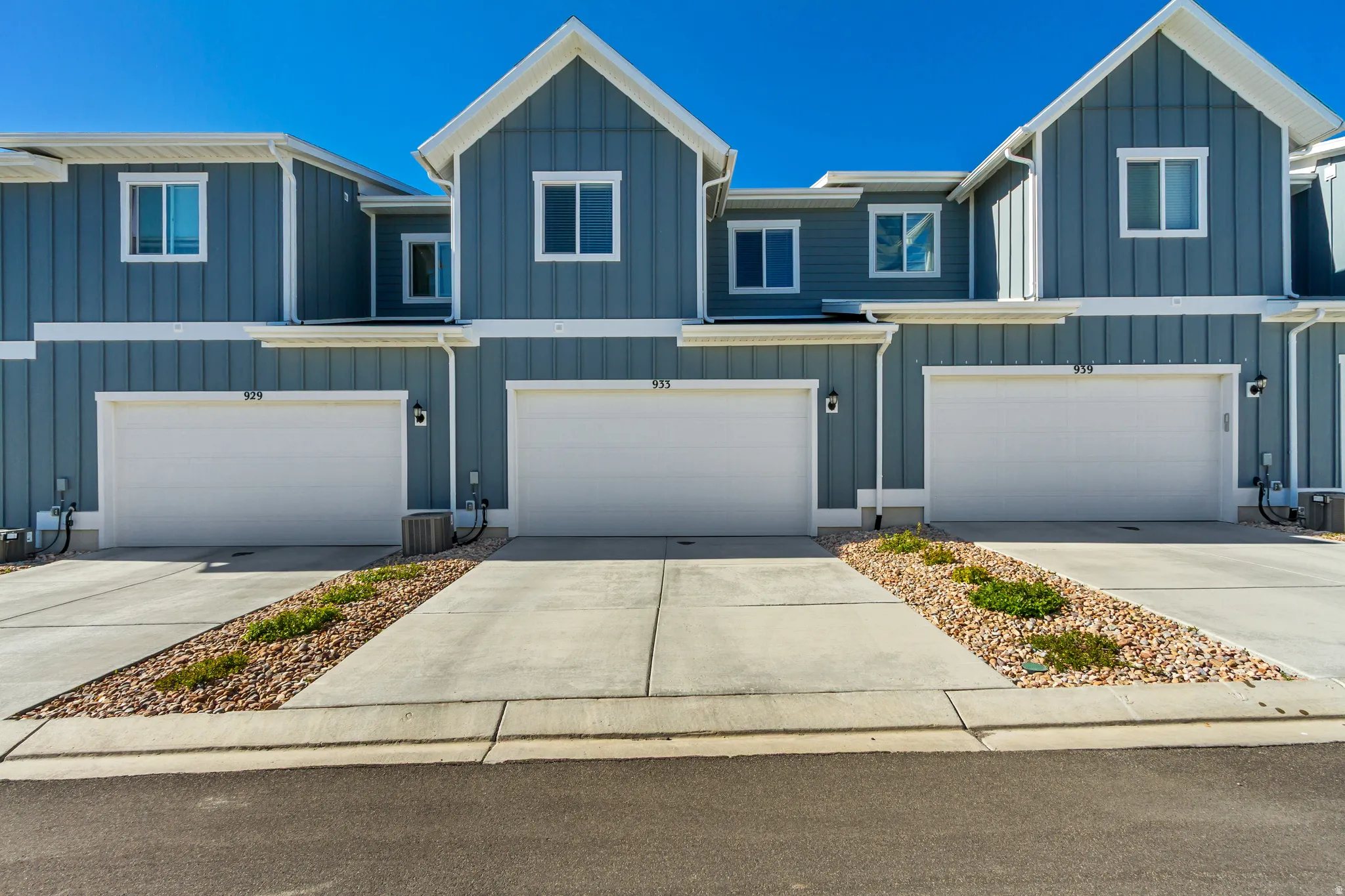 Contemporary townhome exteriors featuring vertical siding and white trim