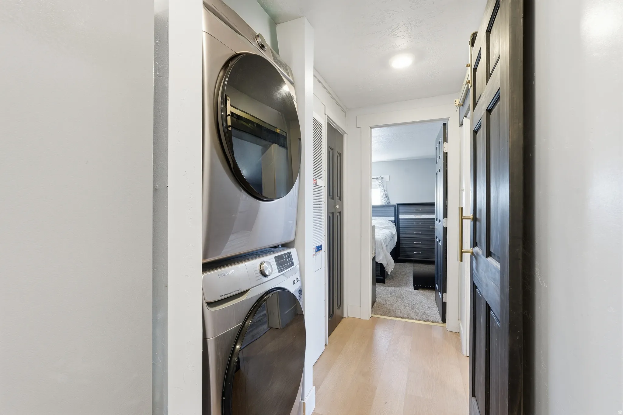 Dedicated laundry area featuring a stacked washer and dryer