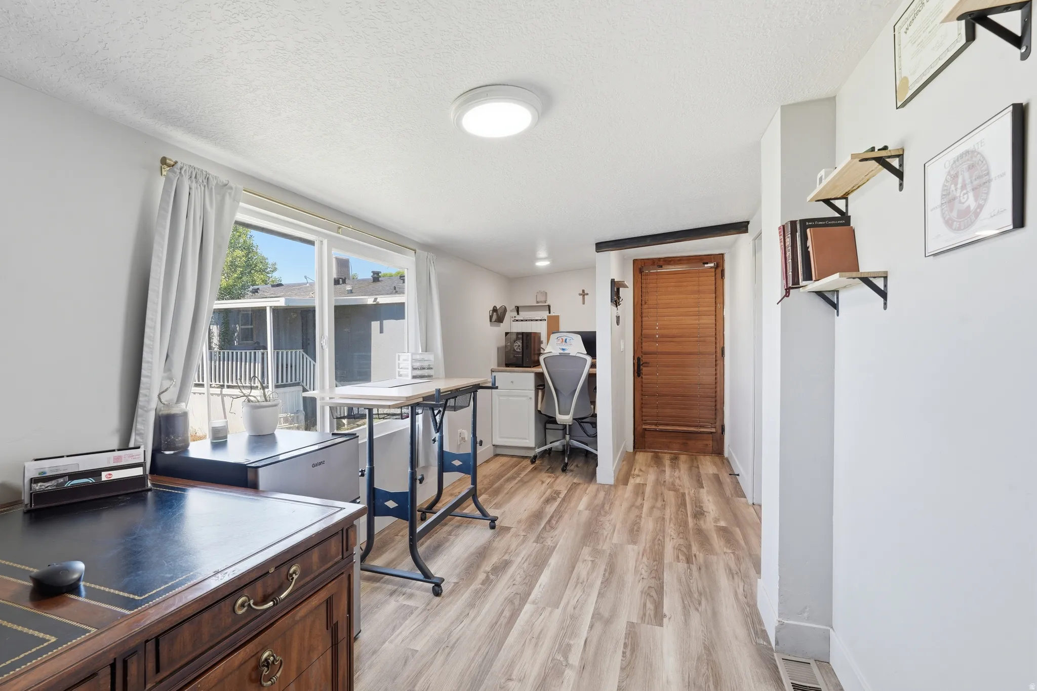 Light wood-finish flooring complements white walls and ceiling