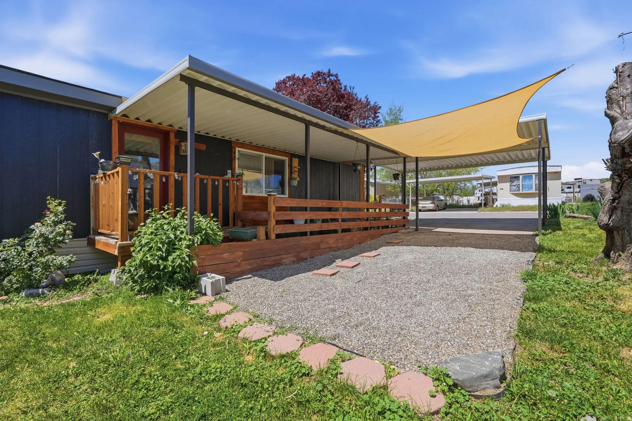 Covered front porch with wood railing and steps