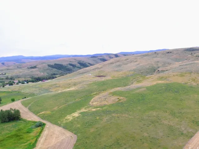 Expansive rolling hills featuring natural terrain and varied vegetation