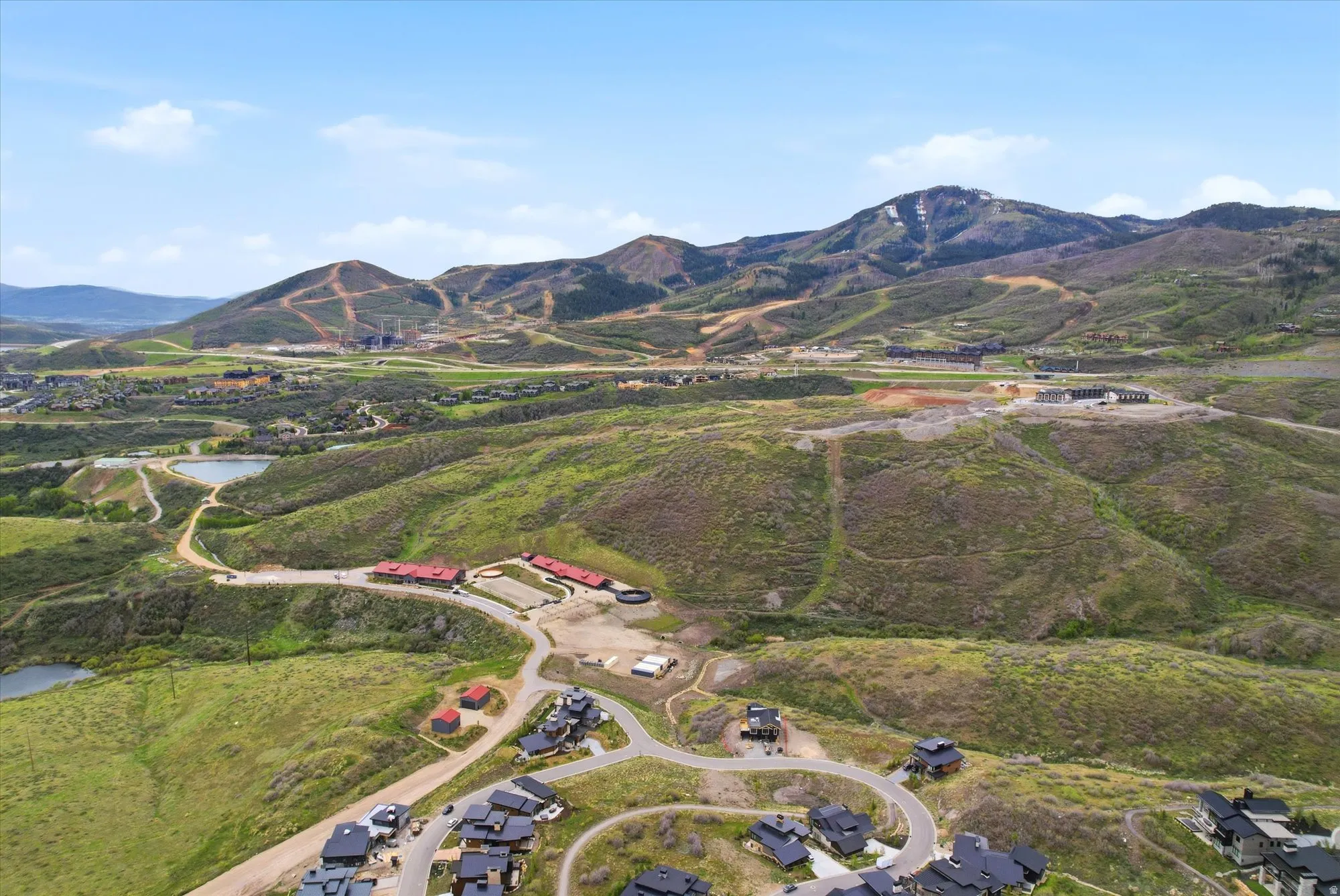 Expansive mountain landscape featuring varied terrain and multiple bodies of water