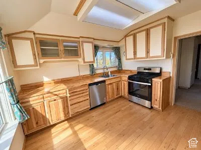 The recently updated kitchen features brand new appliances, butcher block countertop and warm wood cabinetry