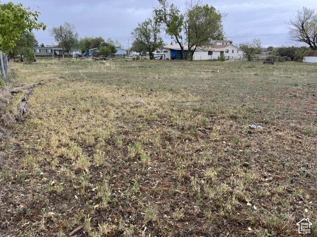 Expansive vacant land parcel with natural, undeveloped landscape.